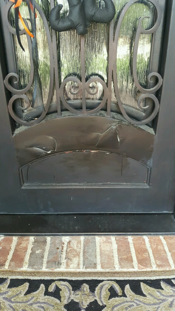 Original door that is chipped and dented.